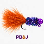 Kai's Custom Jigs PB&J marabou jig with a purple head, iridescent purple body, orange feather tail and downward-facing hook, with a purple and orange PB&J label.