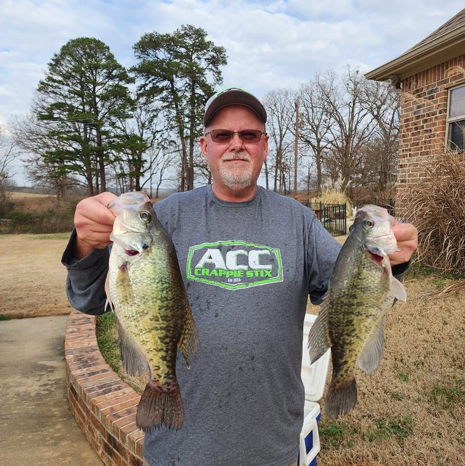 John Maddox Outdoors holding two crappie